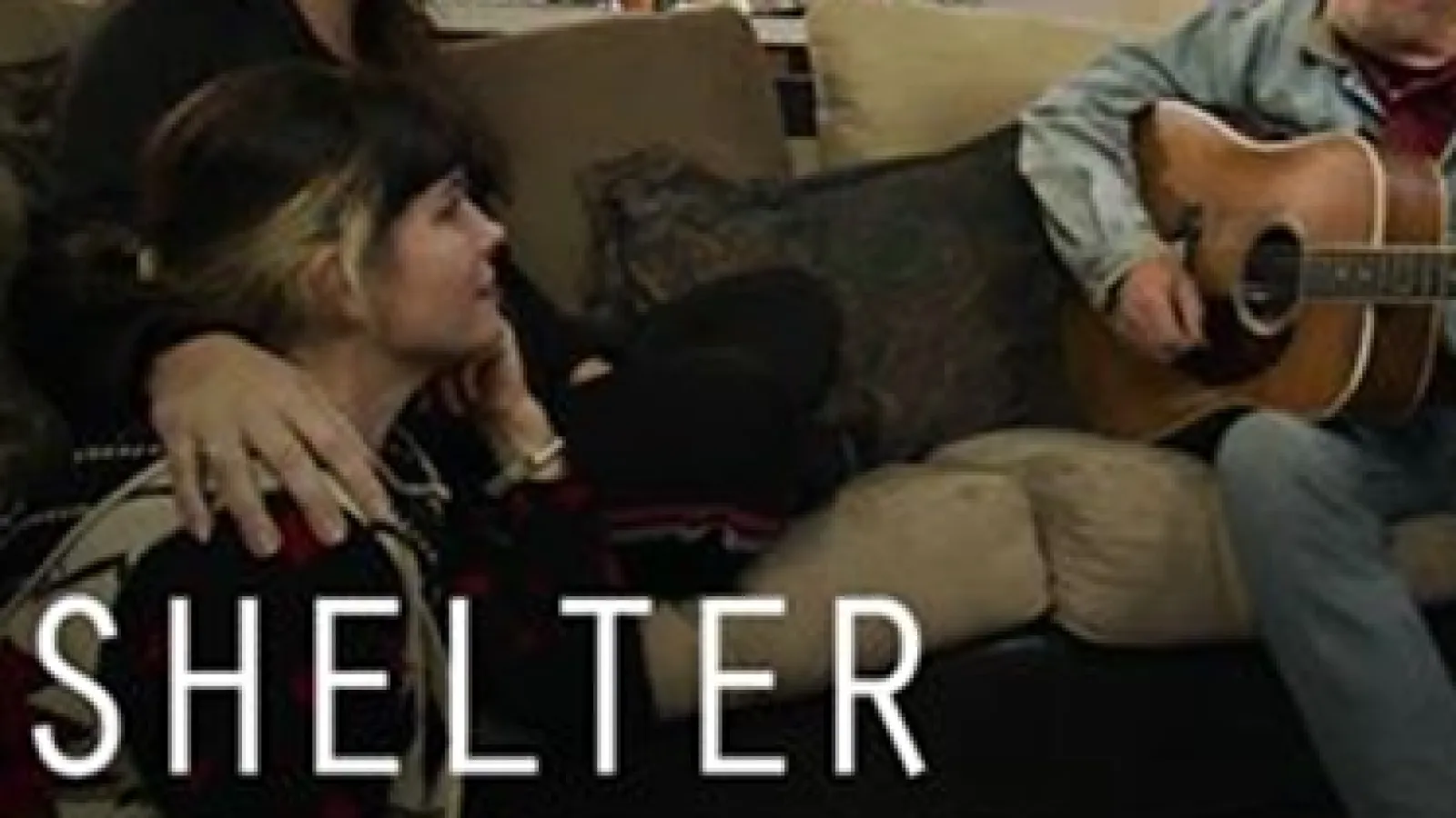 Two people facing a man with a guitar with the words "Shelter, Sunday November 8th, 10pm EST/7 pm PST